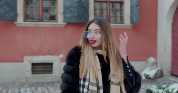 Portrét mladá žena s brýlemi pohled na kameru pózuje v centru města krásné vlasy atraktivní úsměv dívka dáma životní styl — Stock video