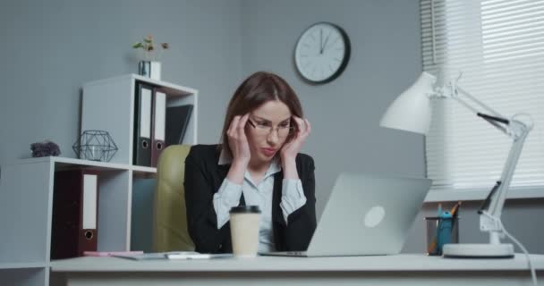 Zakenvrouw is moe en is gestrest. Ik voel me moe en gestrest. Gefrustreerde jonge vrouw die haar ogen dicht houdt terwijl ze op haar werk zit. — Stockvideo