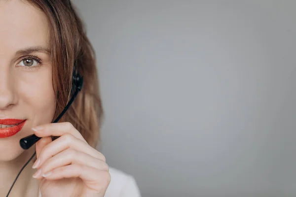 Closeup portrait of beautiful, adorable smiling female customer representative with phone headset pointing at copy space isolated on background. Positive human emotions, facial expressions. — 스톡 사진