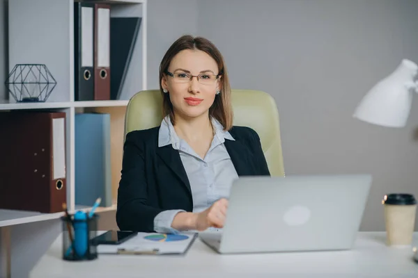 Woman professional using laptop sit at office desk, happy female customer make confirming online website. — 스톡 사진