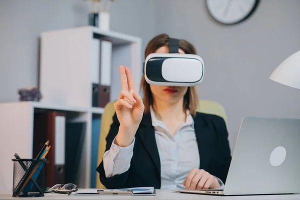 Caucasian female professional woman using augmented reality AR hololens headset to work on a project — Stock Photo, Image