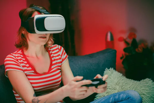 Woman relaxing playing video games using vr headset. Caucasian female gamer