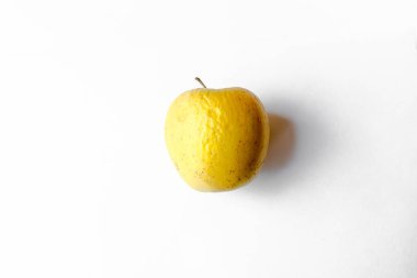 Beyaz arka planda kurumuş sarı elma.