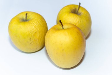 Beyaz arka planda birkaç eski sarı elma