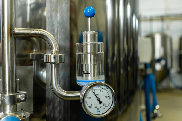 beer equipment inside the brewery. Gates, pipe and taps.