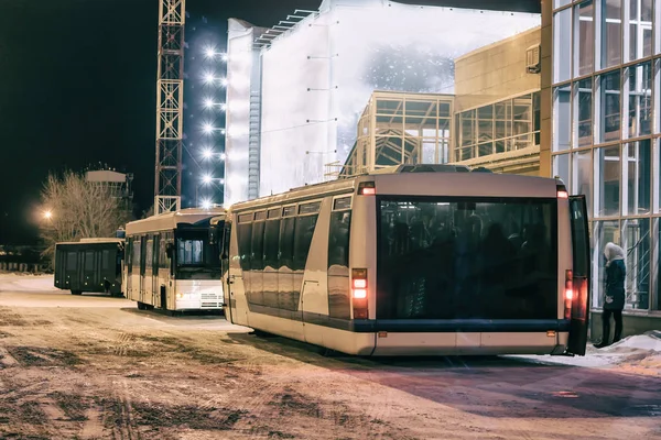 Airport buses near the terminal at night