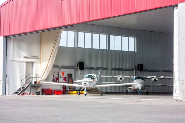 Small aircraft in open hangar — Stock Photo, Image