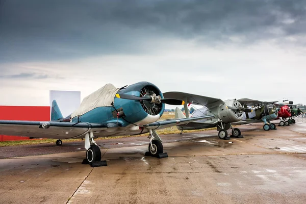 Retro airplanes in the parking lot on a cloudy day