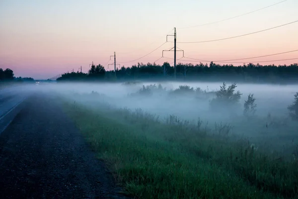 Ground fog near the road at sunset