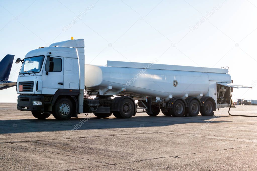 White tank truck aircraft refueler at the airport apron