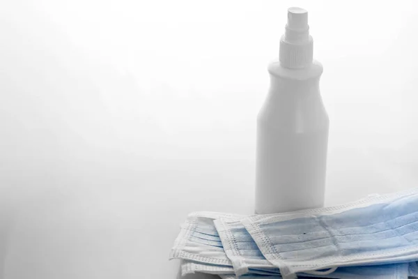 mask and sanitizer on a white background