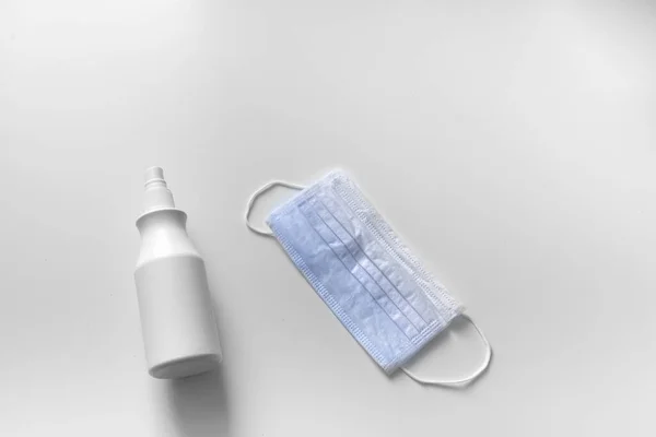 Beyaz arka planda maske ve dezenfektan
