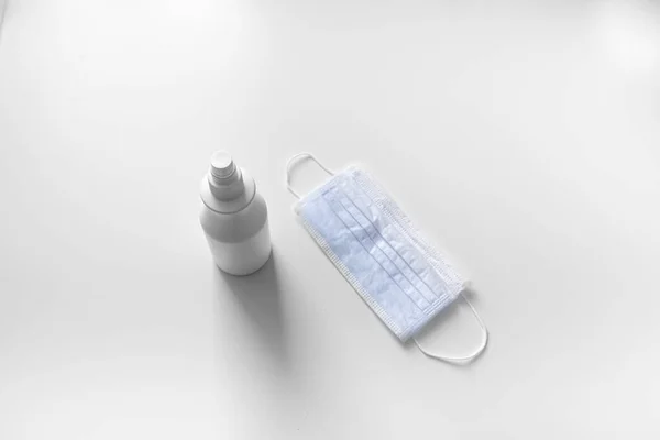 mask and sanitizer on a white background