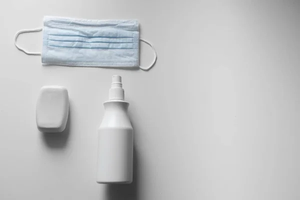 mask and sanitizer on a white background