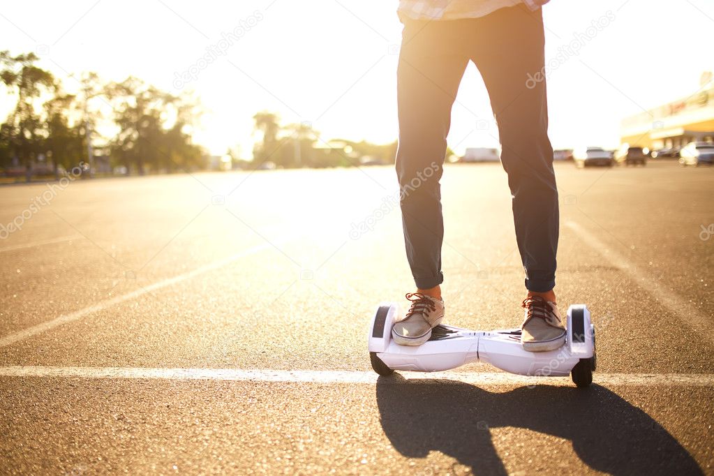 young man and woman riding on the Hoverboard in the park.  Skateboard Smart
