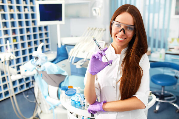 Portrait of a beautiful young girl on the background of the dentist's office.