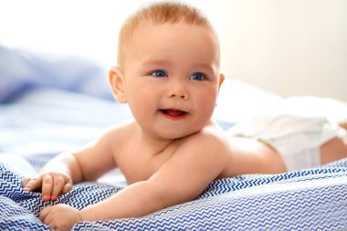 Bebek çocuk güneşli yatak odasında. Yeni doğan çocuk yatakta rahatlatıcı. Genç çocuklar için kreş. Tekstil ve çocuklar için yatak takımları. 