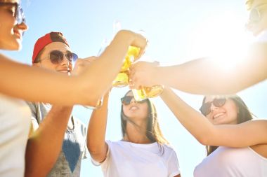Grup arkadaşıyla sahilde bira dışarı asılı. Mükemmel güneşli havalarda. Güzel resimler. Yaz konsepti