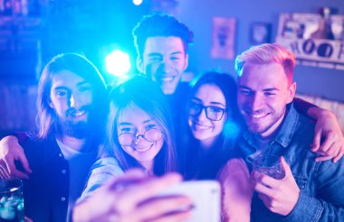 Selfie zaman. Genç grup arkadaşıyla birlikte bir gece kulübünde parti ve içecekler kızartma. Mutlu gençlerle barda kokteyller. İnsanlar büyük bir ruh var ve onlar çok gülümseme