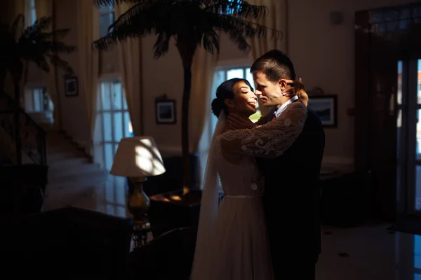 Young married couple in darkness. Newlyweds enjoy each other tenderly. Intimate atmosphere. Luxury elegant wedding couple kissing and embracing. Romantic moment. Together. Wedding.