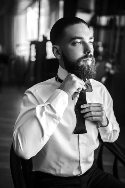 Portrait of elegant groom in suit. Groom morning preparation. Morning of the groom. Wedding day. Marriage.