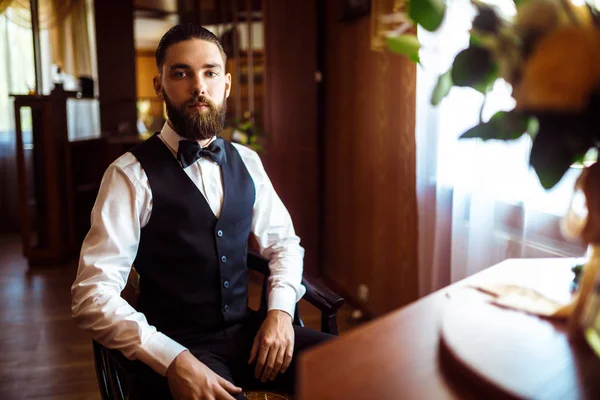 Portrait of elegant groom in suit. Groom morning preparation. Morning of the groom. Wedding day. Marriage.