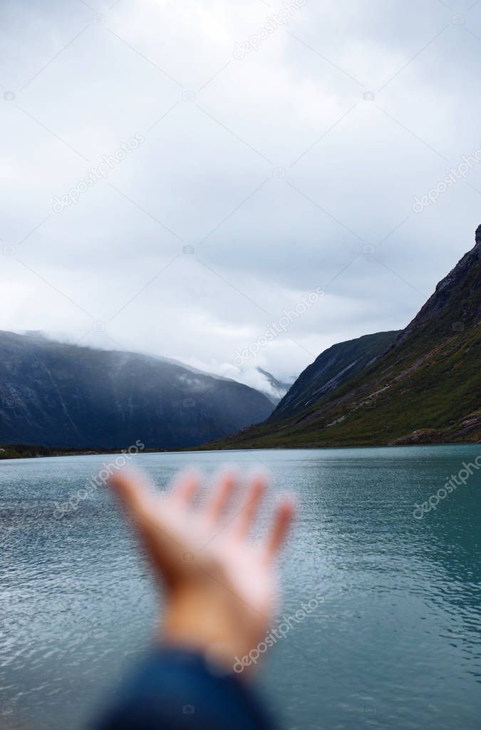 Picturesque landscape  mountains of Norway. Beautiful view of the lake. Rocky shore of mountain lake in the morning. Travelling, lifestyle,  wild nature concept.