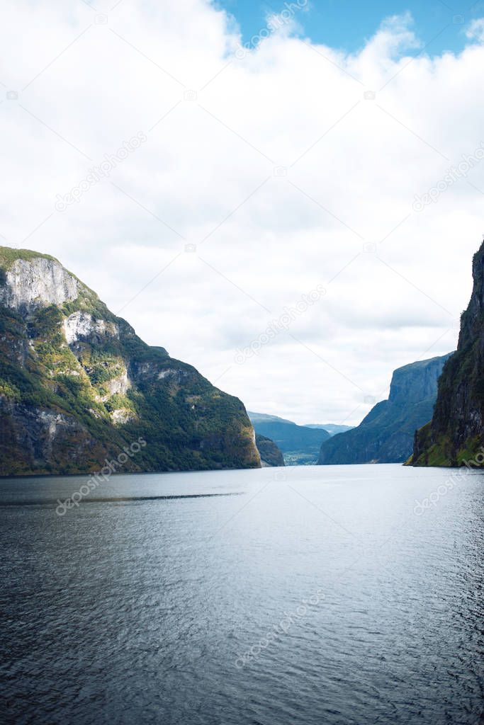 Amazing nature view with fjord and mountains. Beautiful reflection.  Picturesque landscape mountains of Norway. Travelling, lifestyle, wild nature concept.