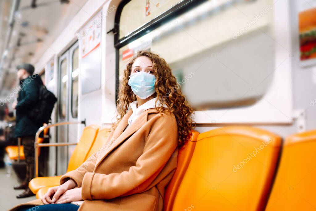 Girl in protective sterile medical mask in the subway car. Woman, wear face mask, protect from infection of virus, pandemic, outbreak and epidemic of disease in quarantine city. 