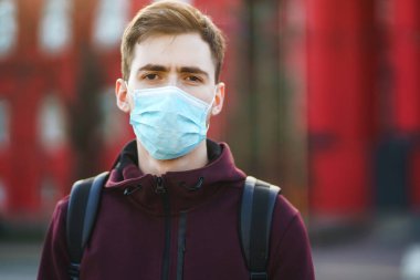 Sokakta yüzünde steril tıbbi maske takan adamların portresi var. Salgının yayılmasını önleme ve koronavirüsü tedavi etme kavramı, karantina şehrinde salgın. Covid 19.