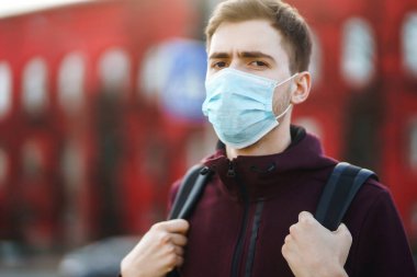 Sokakta yüzünde steril tıbbi maske takan adamların portresi var. Salgının yayılmasını önleme ve koronavirüsü tedavi etme kavramı, karantina şehrinde salgın. Covid 19.