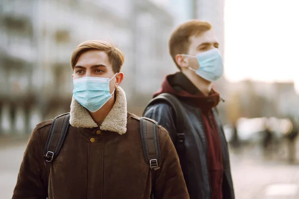 Two Friends in protective sterile medical mask on her face in quarantine city. Friends, wear face mask, protect from infection of virus, pandemic, outbreak and epidemic of disease in quarantine zone.