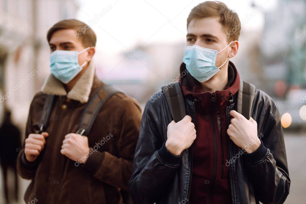 Two Friends in protective sterile medical mask on her face in quarantine city. Friends, wear face mask, protect from infection of virus, pandemic, outbreak and epidemic of disease in quarantine zone. 