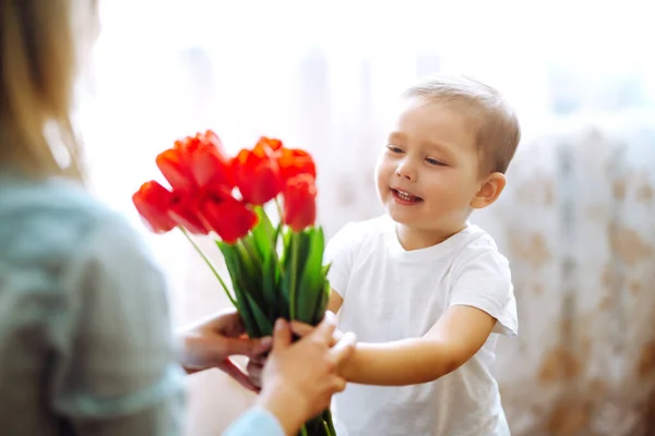 Little Son Congratulates Mother Gives Bouquet Flowers Tulips Happy Mother — Stock Photo, Image