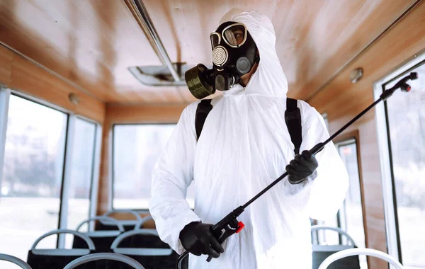 Cleaning and Disinfection public transport.Man in protective suit washing and disinfection public transport, to preventing the spread of the epidemic of coronavirus, pandemic in quarantine city.