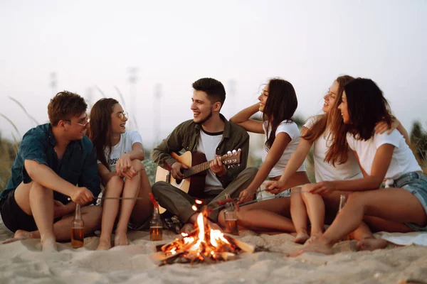 Gruppo Giovani Amici Seduti Sulla Spiaggia Friggere Salsicce Uomo Sta — Foto Stock