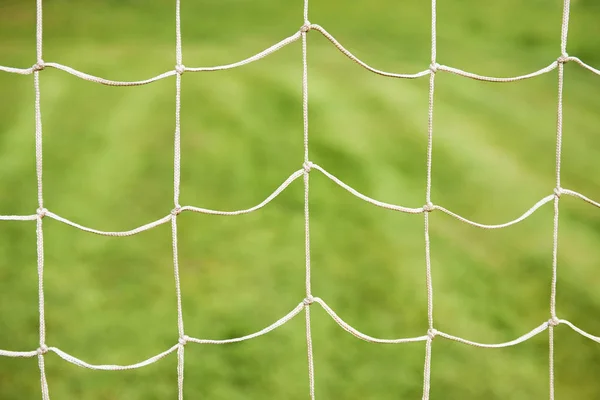 football gate net against green grass field