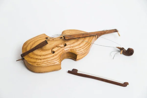 Velho vintage violino quebrado de madeira com arcos no fundo branco . — Fotografia de Stock