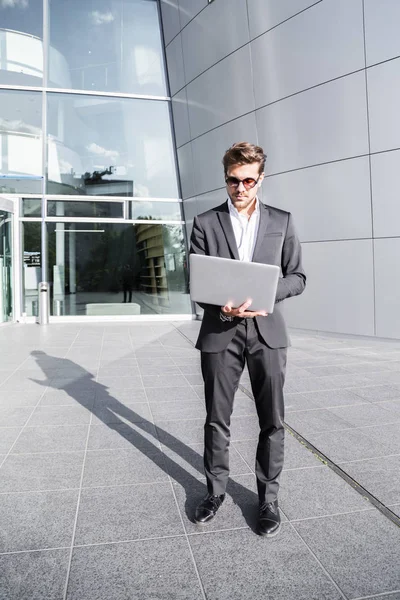 Uomo d'affari o lavoratore in abito nero con laptop — Foto Stock