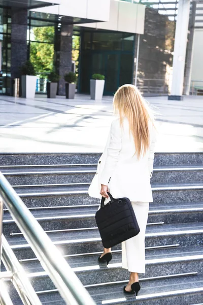 Молодая деловая женщина в белом костюме снаружи — стоковое фото