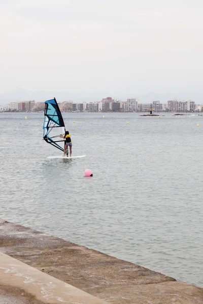 Girl windsurfing near the coast of Rosas in Spain — Stock Photo, Image