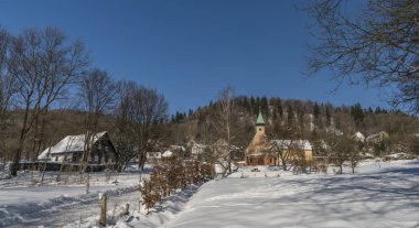 Church in Cereniste village in winter clipart