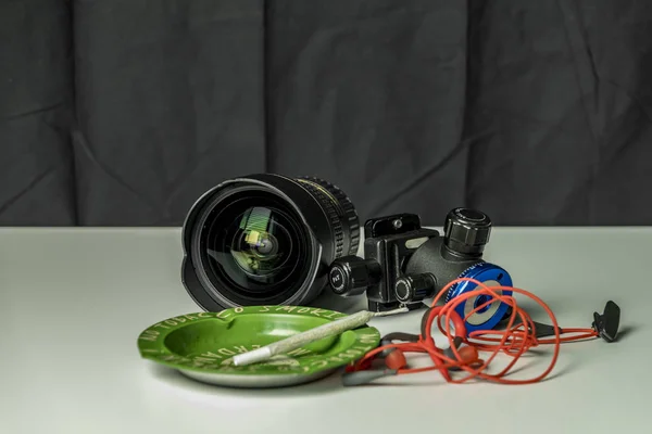 Wide-angle lens with earphone charger and ashtray