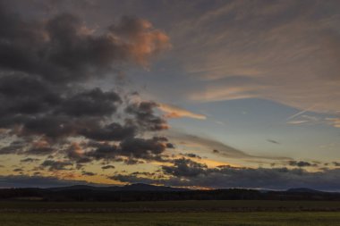 Color sunrise on green field near Vyhen village in south Bohemia