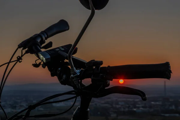 Handlebar mirror and light on electric bike in sunset color nice evening