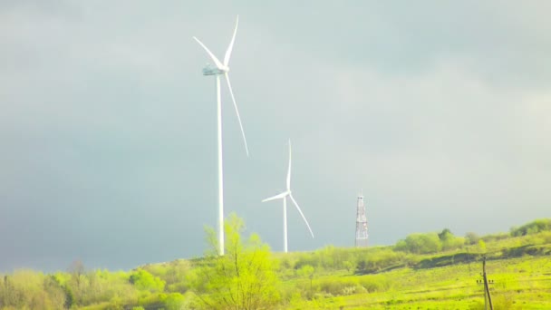 Wind farm with sky and clouds on the mountain with spring green grass — Stock Video