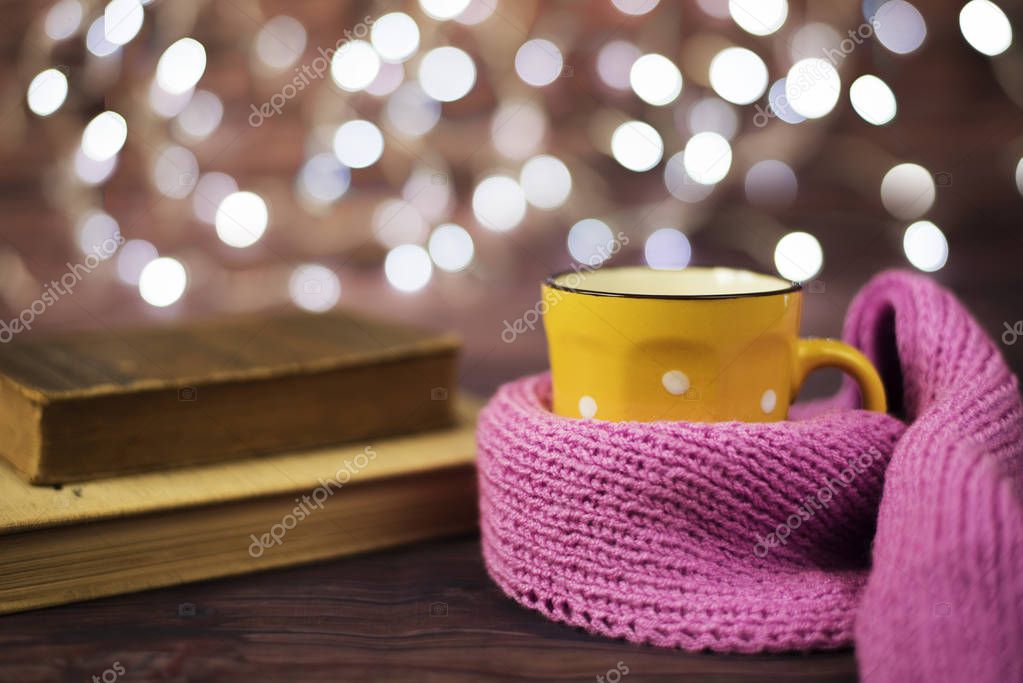 Hot tea, hot chocolate, coffee in yellow cup, wrapped with a pink