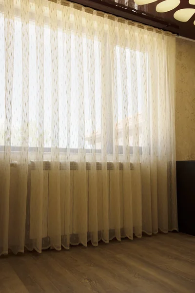 Window with beige sheer curtains, interior decoration concept.