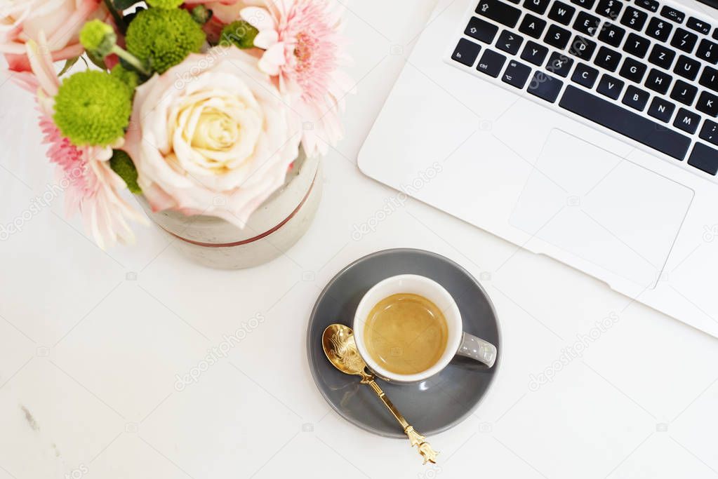 Feminine workplace concept in flat lay style with laptop, coffee