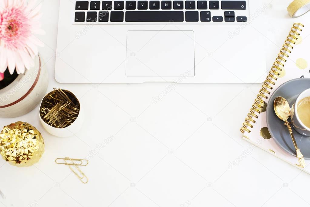 Feminine workplace concept in flat lay style with laptop, coffee